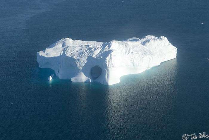 ArcticQ_20080829_155458_918_20.jpg - A large berg, calved from a nearby glacier, shows the effects of water channeling through the ice.  Cape York, Nunavut, Canada.