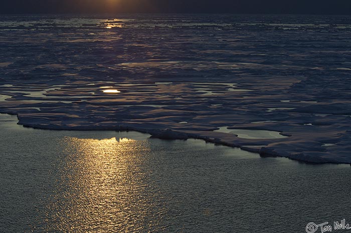 ArcticQ_20080831_212440_535_2X.jpg - The southern limit of the pack ice in Nares Strait betwen Ellesmere Island and Greenland creates a rosy-dark landscape as the sun goes down.