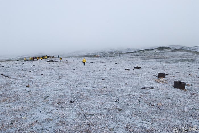 ArcticQ_20080901_102254_362_20.jpg - Dressed alike in their yellow parkas, the passengers are clearly visible in the sea fog at Fort Conger, Ellesmere Island, Canada.