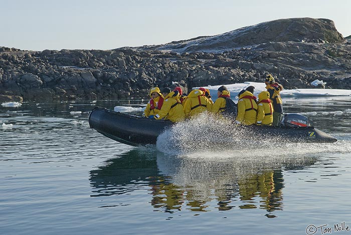 ArcticQ_20080903_105556_028_20.jpg - A zodiac builds some speed to break through skim ice and land on Skraeling Island, Nunavut, Canada.