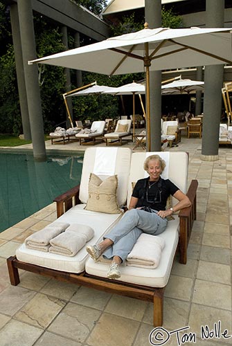 Africa_20081027_115640_084_20.jpg - Linda takes a rest on a comfortable pool-side chair while awaiting dinner at the Saxon Hotel Johannesburg South Africa.