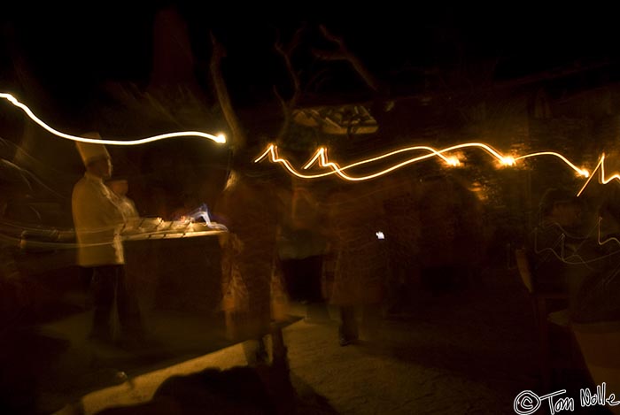 Africa_20081029_145304_122_20.jpg - Dining staff with lights create a flow of illumination in the bombe dinner scene.  Madikwe Reserve, South Africa.