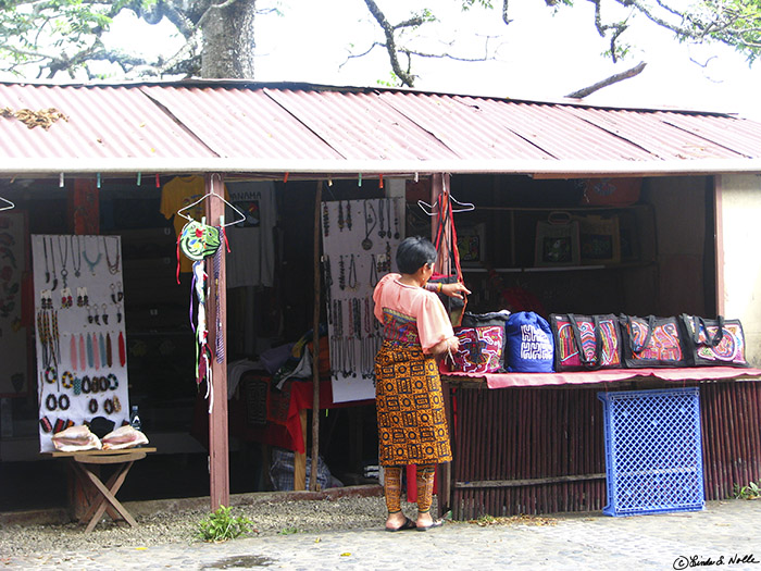 CostaRica_20100317_100218_046_S.jpg - A shopkeeper straightens out her goods to show them off to tourists as we wait for a dance performance in the town square.  Portobelo, Panama.