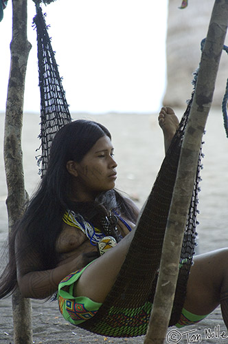 CostaRica_20100319_121112_093_2X.jpg - A young woman rests in a hammock, a part of a tribal life that is primitive and occasionally challenging but often also one of easy gathering of food.  Playa de Muerto, Darien, Panama.