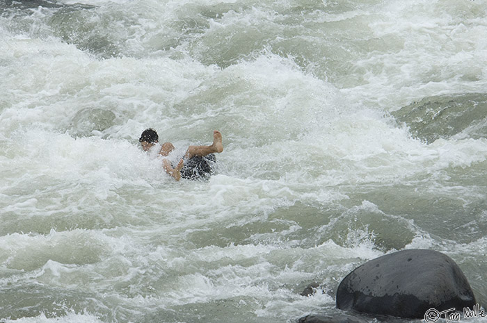 CostaRica_20100327_163312_395_2X.jpg - A boy rides an inner tube down the rapids in Sarapiqui Costa Rica.