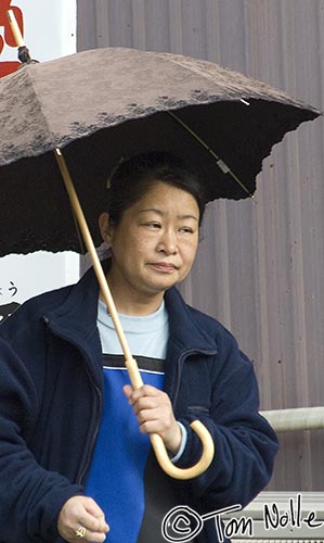 Japan_20080411_021308_423_2X.jpg - A woman looks resigned to a light rain in Kyoto Japan.