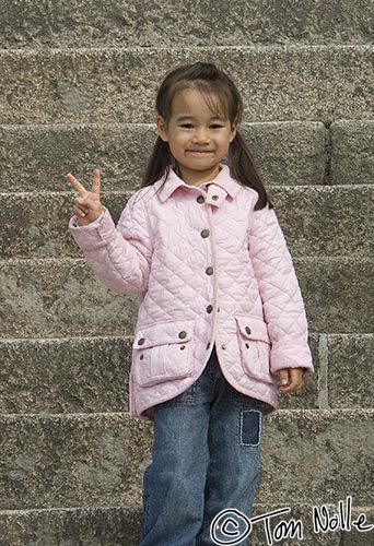 Japan_20080412_022256_666_2X.jpg - A young girl offers a hand greeting common among young Japanese while waiting at the Kiyomizu temple gate Kyoto Japan.