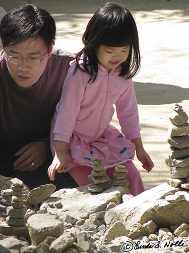 Japan_20080419_211612_353_S.jpg - A child builds what in Alaska would be called an Inukshuk.  Bulkugsa temple Kyongju South Korea