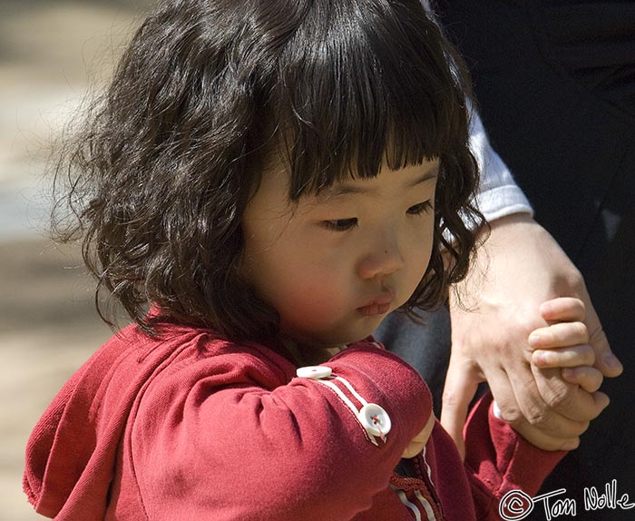 Japan_20080419_212622_606_2X.jpg - A young Korean girl seems pensive during her visit to Bulguksa temple Kyongju South Korea