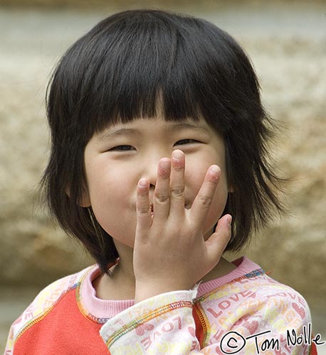 Japan_20080422_221622_213_2X.jpg - Or maybe the whole hand; it's hard to tell what this young lady is up to.  Shikoku-Mura, Takamatsu, Japan.