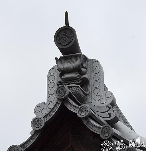 Japan_20080410_204944_297_2X.jpg - The peaks of tile roofs on Buddhist temples often have rather sinister looking adornments.  This is in part of the Rukuon-Ji temple complex adjacent to the Golden Pavilion Kyoto Japan.