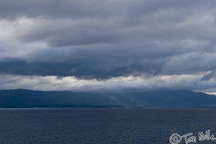 Japan_20080417_174446_030_20.jpg - A shaft of sun lights an otherwise stormy scene as we approach Kagoshima Japan.