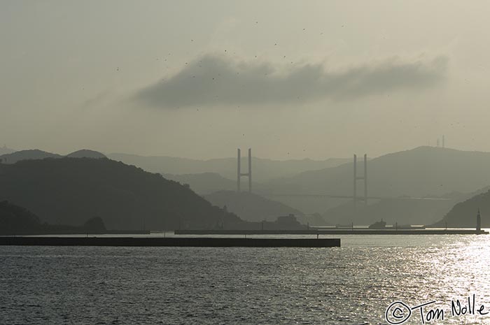 Japan_20080418_175256_262_2X.jpg - Birds wheel in the sky above a suspension bridge as we head into Nagasaki Japan.