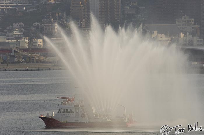 Japan_20080418_182010_335_2X.jpg - The plumes of water from this welcoming fireboat seem almost like decorative plumage.  Nagasaki Japan.