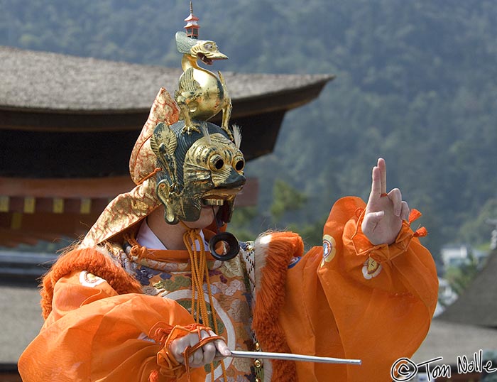 Japan_20080421_203856_909_2X.jpg - This dancer almost appears to be conducting music.  Itsukushima shrine, Miyajima, Japan.