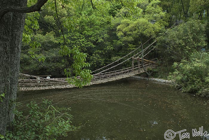 Japan_20080422_214648_873_20.jpg - An old rope bridge over a dark pond in the restored 16th-century village of Shikoku-Mura, Takamatsu, Japan.