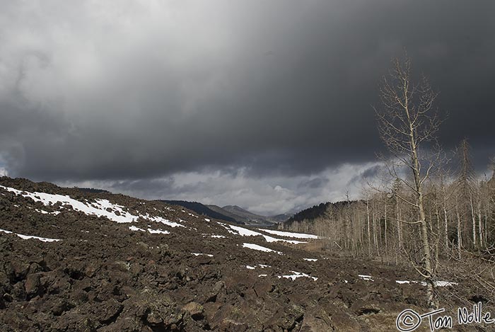 Canyonlands_20080526_124310_626_20.jpg - A lava bed spotted with snow patches broods under a stormy sky near Navajo Lake Utah.