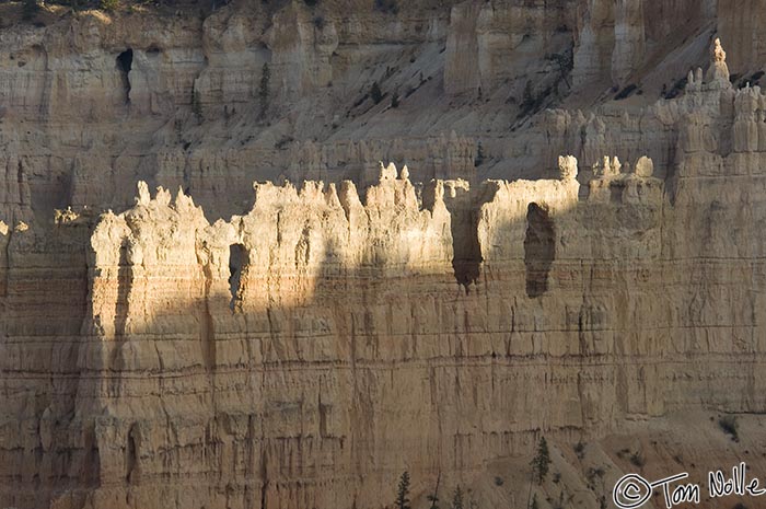 Canyonlands_20080526_214720_109_2X.jpg - The shadow of the rim creeps upward to cover more of the white stone of this dramatic bridge-with-a-keyhole in Bryce Canyon Utah.